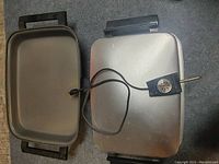Top view of the fry pan showing the removable lid, black handles, and attached temperature control with power cord.
