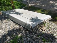 Top cover folded or stacked, showing surface and metal edging.