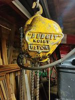 Close up of yellow Dodge branded hoist body with '1/2 Ton' lifting capacity stamp.