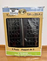 Front view of the original packaging showing two black metal floor registers inside box with Hampton Bay branding and size 3x10 inches.