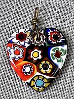 Close-up view of front of heart-shaped Murano glass pendant showing distinct floral pattern.