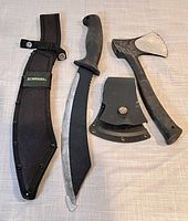 Full view of knife with black nylon sheath, knife handle and blade visible, along with small axe and its plastic sheath.