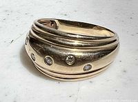 Front angle showing wave design and diamond settings