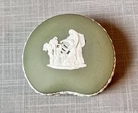Top view of heart-shaped green Wedgwood jasperware trinket box with white classical figure bas-relief on the lid