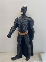 Full view of the large Batman action figure showing black costume, cape, and sculpted muscle details.