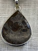 Close-up front image of teardrop-shaped Mud Crack Jasper pendant set in sterling silver bezel, showing detailed cracked patterns in the jasper stone.