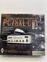 Photo of the front of the boxed Uniden Bearcat PC78XL CB radio, showing the product name, image of the radio unit with microphone, and key features noted on the box.