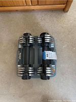 Top view of Reebok Speed Pac 25 adjustable dumbbells on the stand showing the dumbbells and stand as a whole.