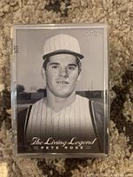 Black-and-white vintage style Pete Rose baseball card in a protective case.