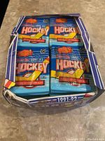 Box of 1991-92 OPC hockey card packs showing the top side of the box with multiple sealed packs inside, displaying the distinctive blue and yellow design and the year 1991-92.
