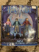 Front view of sealed Harry Potter mini figurines package featuring Hermione, Harry, and Ron.