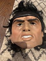 Close-up front view of the Rambo latex mask showing facial features and hair.