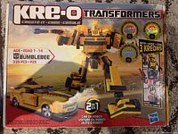 Front of the Kre-O Transformers Bumblebee build set box showing 2-in-1 robot and car build with piece count and included Kreons figures.