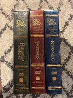 Spine view of the three DVD cases showing the titles and Special Extended DVD Edition label in gold embossing on green, brown, and blue leather-textured cases.