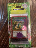 Full view of sealed Metazoo Wilderness 1st Edition blister pack containing promo card and coin.