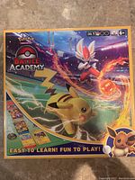 Front of boxed Pokemon Battle Academy set with Pikachu and Cinderace artwork