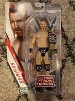Front view of Sheamus WWE action figure in sealed packaging showing figure and championship belt