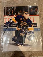 Full view of the 8x10 photo showing Curtis Joseph in action on ice and the full autograph.