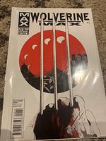 Front cover of Wolverine Max Issue #1 comic book showing Wolverine's claws and red circular background.
