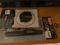 Package of Optex Snap-On Lens Cap and Lens Pen for camera lens cleaning