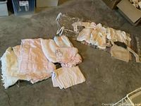 General overview of all the fabric items including sweaters and bedding laid out on floor.