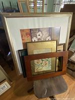 Overall view of the set of 5 framed pictures stacked together, showing various frame styles and sizes