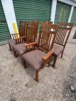 Full view of six mission style dining chairs arranged in two rows showing backs and upholstery.
