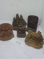 Five assorted vintage bookends and figurines arranged on a white background.
