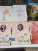 Overview of all six boxed Barbies arranged on table
