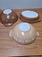 Photo of three vintage Pyrex bowls showing bottoms with no chips or cracks.