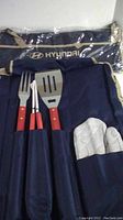 Two sets of Hyundai branded navy blue BBQ utensil carrying cases with visible fork, spatula, tongs, and oven mitt in pockets.