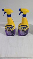 Two yellow spray bottles of Zep Industrial Purple Degreaser each with 946 ml capacity, having blue and yellow trigger sprayers, displayed on a white surface.