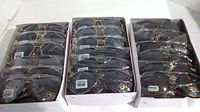 Three open boxes filled with 12 individually wrapped aviator style sunglasses each, showing metal frames and dark lenses with UV400 label.