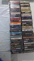 Photo showing a stacked collection of cassette tapes, various classic rock and hard rock artists visible.