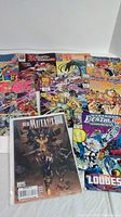 Photo showing a spread of nine Marvel comic books with colorful covers featuring various characters and titles including New Mutants, Deathlok, Knights of Pendragon, Bishop, Dark Angel, and Arc Rider.