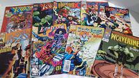 9 Marvel comic books including X-Men, Wolverine, Deathlok, Dark Angel displayed fanned out.