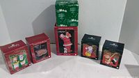 View of 5 Carlton Cards Heirloom Christmas ornaments still in original packaging, and one Enesco musical box in green and white Christmas box.