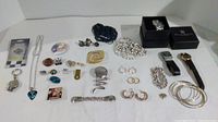 Overview of lot showing 3 wristwatches, multiple bracelets, earrings, pins, and other costume jewelry.