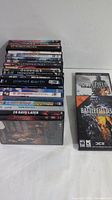 Various DVD movie cases stacked and two PC game cases for Battlefield series on the side