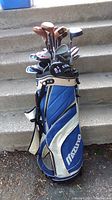 Full view of Mizuno golf bag with clubs inside showing corner of stairs