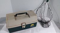 Full view of beige and dark green Plano tackle box with handle and front latch