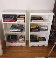 Both white painted wood bookshelves shown side by side filled with books to display spacing and size.