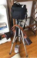 Photo of the Blacks BT-50 tripod fully extended with cases and box on floor