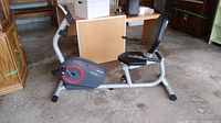 Side view of HealthRider H22X recumbent exercise bike showing seat, pedals, and flywheel casing.