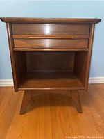 Front view of the Gibbard night stand showing one wood drawer and open lower shelf.