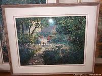 Framed garden pathway print with table and chairs in a natural outdoor setting