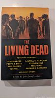 Front cover of The Living Dead book showing zombies and author names.