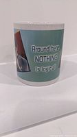 Opposite side of the mug featuring text 'Around here, NOTHING is logical!' on light blue background.
