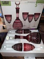 Box of Gabbay crystal decanter set with ruby red color and detailed cut patterns