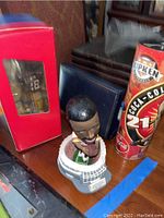 Cal Ripken Jr. bobblehead in baseball uniform with stadium base and collectible Coca-Cola can featuring Cal Ripken Jr. design.